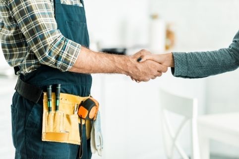 plumber handshaking with customer after quality services in Masdar