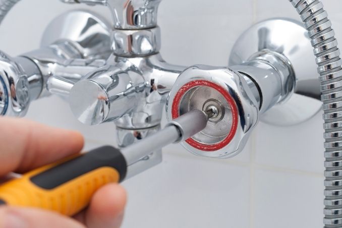 plumber is replacing faucet in Abu Dhabi